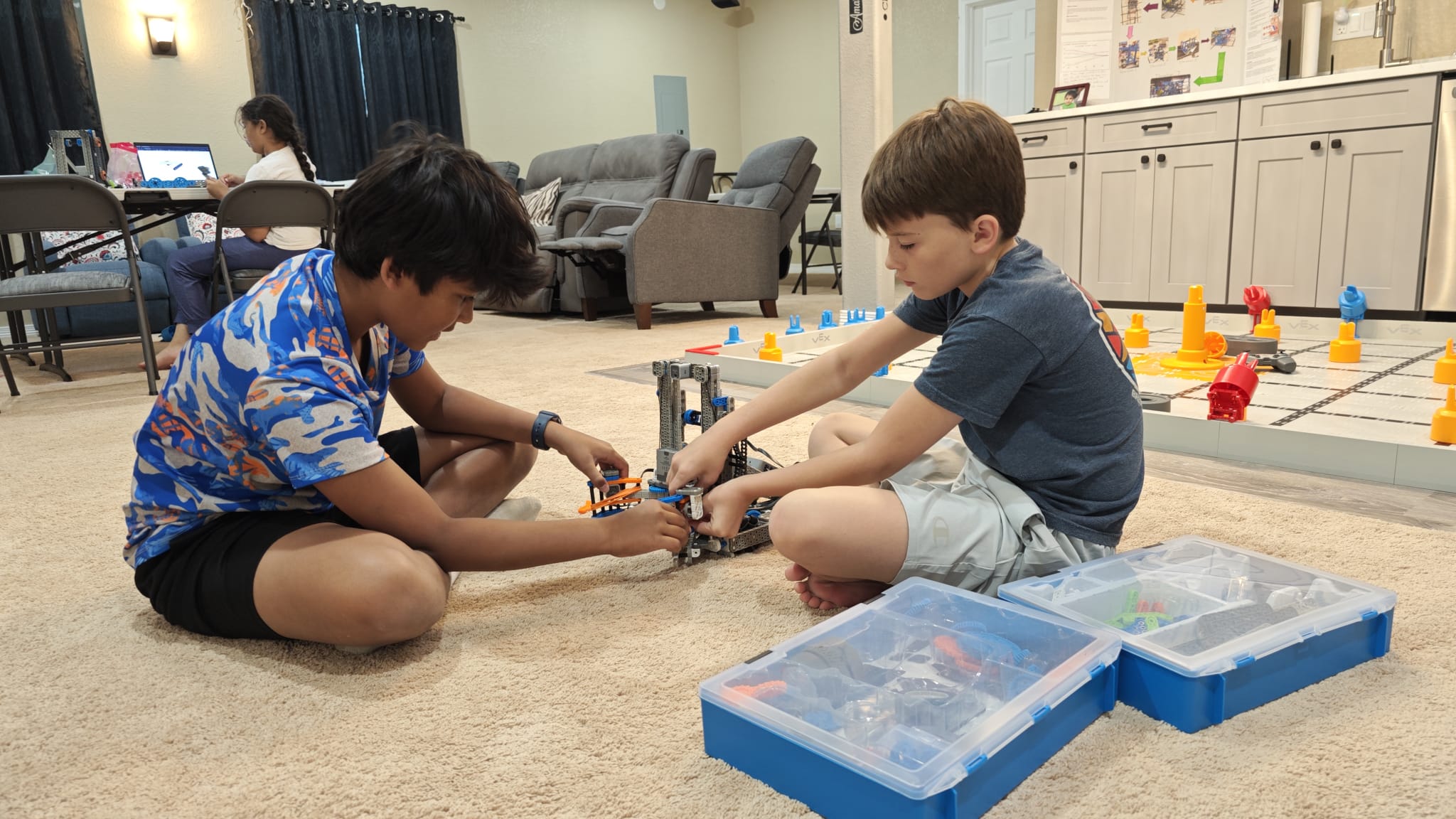 Coach walking students through robot programming at Rocky Robotiqs